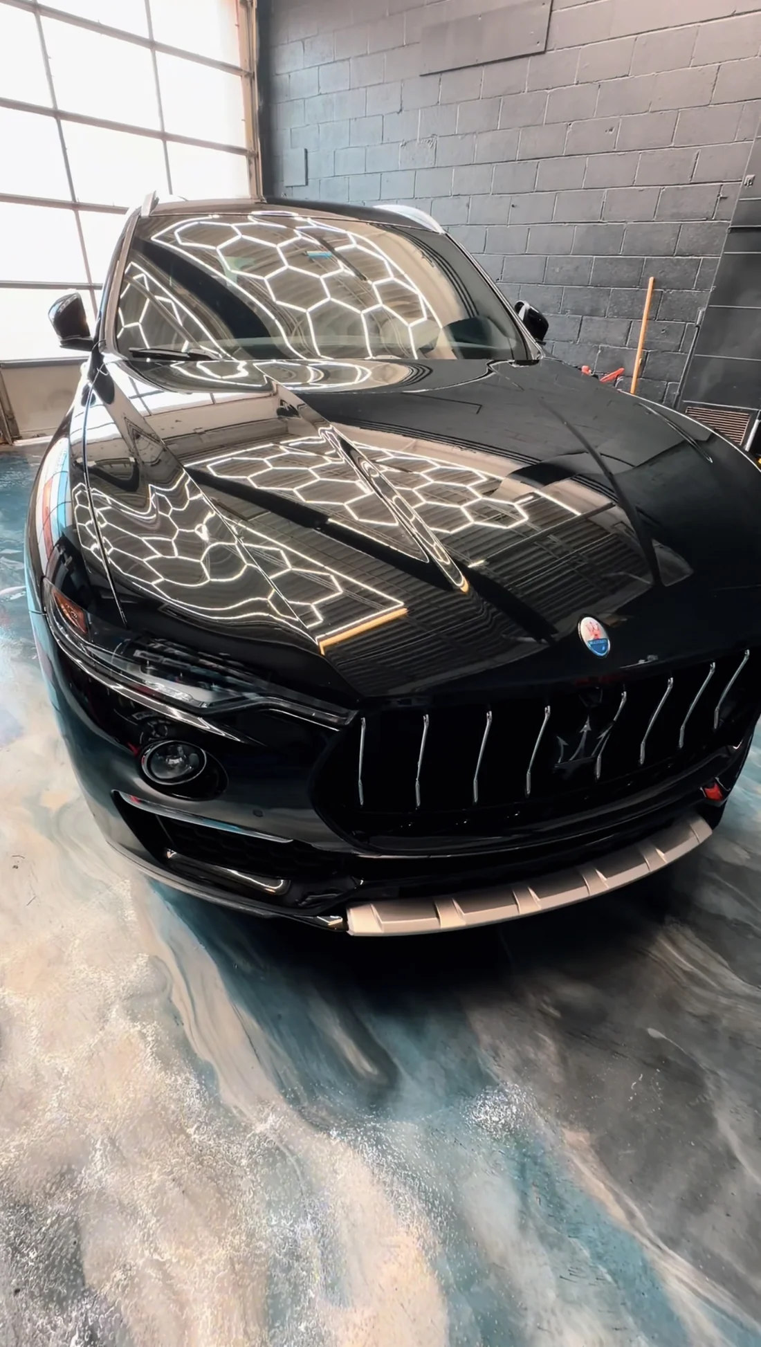 Black Maserati photographed inside the detailing studio
